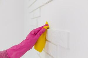 Cleaning Service Worker, hand in protective rubber gloves holding microfiber photo