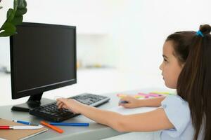 Pretty stylish schoolgirl studying homework math during her online lesson at home, social distance during quarantine, self-isolation, online education concept, home schooler photo