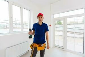 Portrait of cheerful young worker posing looking at camera and smiling enjoying work photo