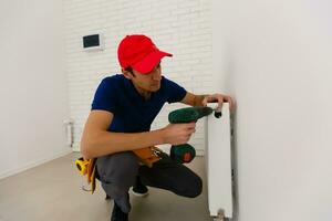 Portrait of cheerful young worker posing looking at camera and smiling enjoying work photo