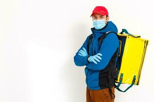 Young courier with thermo bag on white background. Food delivery service photo