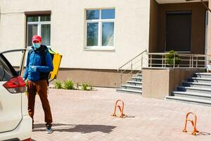 delivery man send food bag at door knob for contactless or contact free from delivery rider in front house for social distancing for infection risk. photo