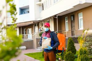 delivery man send food bag at door knob for contactless or contact free from delivery rider in front house for social distancing for infection risk. photo