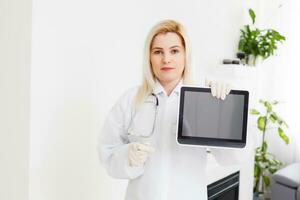 Female Doctor Holding Tablet PC. Doctor's hands close-up. Medical service and health care concept. photo