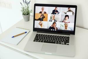 Man Working From Home Having Online Group Videoconference On Laptop photo