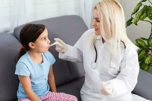 Little girl and young doctor in hospital photo