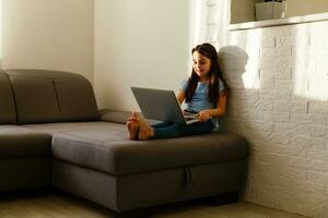 Little girl studying homework math during her online lesson at home, social distance during quarantine, self-isolation Copy space Banner photo