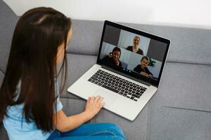 Cute little girl using laptop at home. Education, online study, home studying, distance learning, schoolgirl children lifestyle concept photo