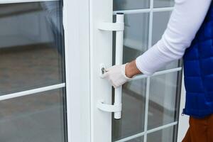 A hand in a blue medical glove opens the door. Hygiene concept. photo