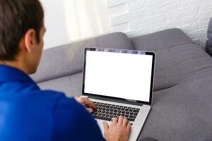 Cropped image of a young man working on his laptop, rear view of business man hands busy using laptop, young male student typing on computer sitting photo