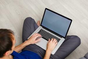 Cropped image of a young man working on his laptop, rear view of business man hands busy using laptop, young male student typing on computer sitting photo