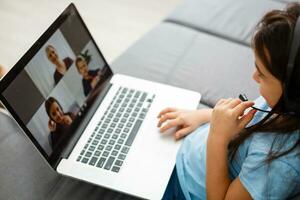 Little girl studying homework math during her online lesson at home, social distance during quarantine, self-isolation Copy space Banner photo