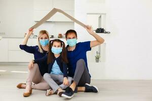 father, mother and daughter wearing protective masks on white background. photo