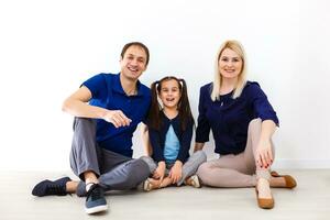 Happy to be a family. Happy family smiling while sitting indoors photo