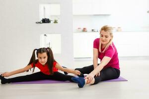 Mother and daughter doing exercise home photo