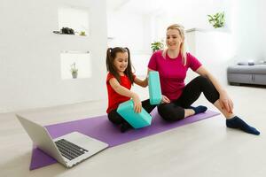 Living room fitness workout girl doing exercises at home. Young woman training muscles, healthy lifestyle without going to the gym. photo