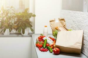 food bags at home in the kitchen. health concept. order of products online. Delivering products to home photo