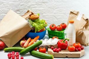 Different set of products to order in paper bags on white background photo