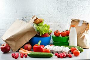 food bags at home in the kitchen. health concept. order of products online. Delivering products to home photo