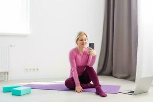 Horizontal view of a woman doing yoga at home photo