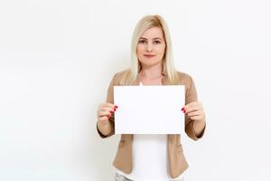 Your text here. Pretty young excited woman holding empty blank board. Studio portrait on white background. Mock up for design photo