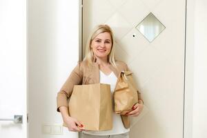 Smiling Woman brought ordered food From Delivery At Home photo