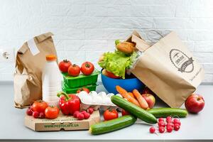 Different set of products to order in paper bags on white background photo