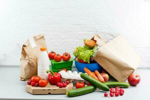 Different set of products to order in paper bags on white background photo