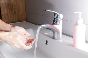 man washing hands isolated over white background photo