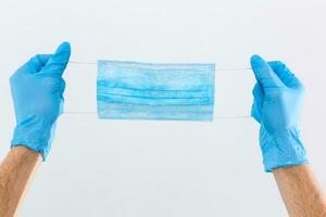 Hand give to surgical mask for protect PM 2.5 and corona virus isolated on white background with clipping path photo