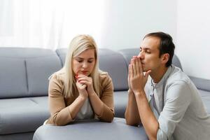 woman and man pray at home photo