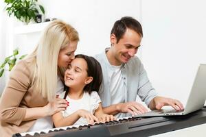 Happy family, mother, father and daughter playing piano at home, concept for family relationship. music school and music family. photo
