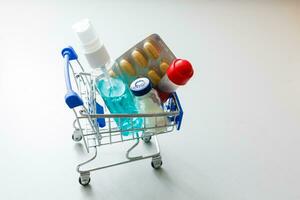 Full shopping cart of pills on white background. photo