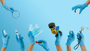 many hands holding medical tools on blue photo