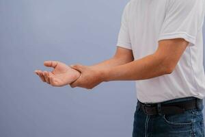 Man wearing white shirt showing back pain photo