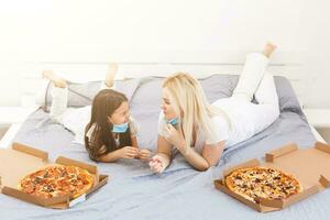 Young family at home, mother and daughter buy foods pizza online during quarantine, Concept delivery photo