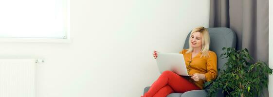 picture of happy woman using laptop at home photo