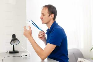 Portrait Of Young Man Inhaling Through Inhaler Mask photo