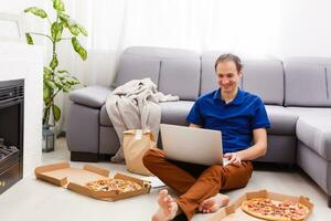 Man using laptop for online food order during quarantine, closeup. Delivery service photo