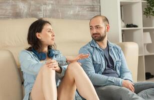 Couple relaxing on parquet and having a conversation. photo