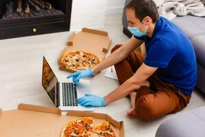 man with pizza at home during quarantine photo