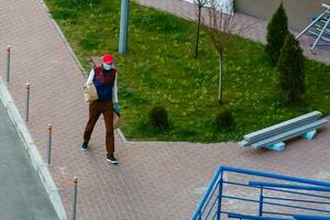 food delivery man on empty street producer of quarantine photo