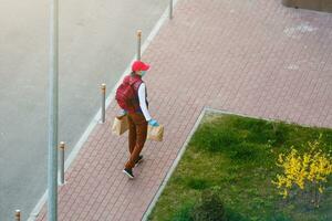 food delivery man on empty street producer of quarantine photo