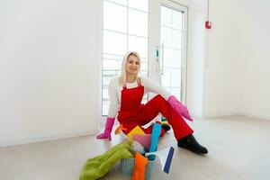 Beautiful young woman makes cleaning the house. Girl rubs dust. photo