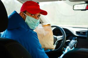 food delivery man Wearing Medical Mask. Corona Virus Concept photo