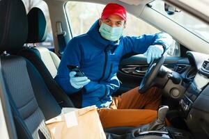 food delivery man Wearing Medical Mask. Corona Virus Concept photo