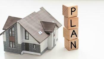 Real estate or property concepts with plan text and model house.business investment and financial. photo