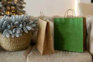 christmas, holidays, presents, new year and decor concept - close up of delivery packages brown mail paper and decorated with fir brunch. photo