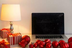 Christmas decorated working space with a laptop on the desk, social media holiday concept with blank space for a text photo