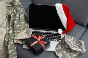 military uniform and a Santa hat with a laptop photo